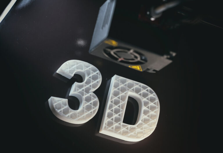3D printing concept. 3D letters ABS white color against black background, Thermoplastic material from polylactic (pla) acid.